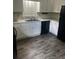 Functional kitchen with white cabinets, laminate counters, modern flooring, and appliances at 2475 Cajun Dr, Marietta, GA 30066