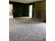 Spacious living room featuring plush carpeting, a brick fireplace, and an access door at 2475 Cajun Dr, Marietta, GA 30066