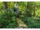 Treehouse located in the backyard in a wooded area with an access bridge made of wood at 401 Emory Ne Dr, Atlanta, GA 30307
