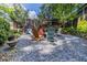 Landscaped backyard with stone pathway leading to an outdoor sitting area with multiple chairs at 401 Emory Ne Dr, Atlanta, GA 30307