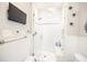 Bathroom with glass door shower, white wainscoting, and grey accent tiles at 401 Emory Ne Dr, Atlanta, GA 30307