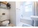 Bathroom with a shower/tub combination, wainscoting, and a pedestal sink at 401 Emory Ne Dr, Atlanta, GA 30307