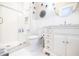 Elegant white bathroom with glass door shower, marble counter, and white hexagon tile floor at 401 Emory Ne Dr, Atlanta, GA 30307