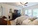Bright bedroom with a dark wood dresser, large television, and view of window seating at 401 Emory Ne Dr, Atlanta, GA 30307
