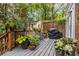 Exterior deck area featuring a lattice design, a grill, and planters with flowers and plants at 401 Emory Ne Dr, Atlanta, GA 30307
