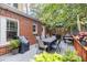 Outdoor deck with a dining table, chairs, grill and lush greenery surrounding the space at 401 Emory Ne Dr, Atlanta, GA 30307