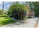 Brick home featuring a driveway with brick trim, stone accents, and mature trees at 401 Emory Ne Dr, Atlanta, GA 30307
