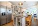 Open kitchen with a large island, stainless steel appliances, and bright lighting at 401 Emory Ne Dr, Atlanta, GA 30307