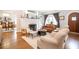 Cozy living room with hardwood floors, a fireplace, and an open view into the dining room at 401 Emory Ne Dr, Atlanta, GA 30307