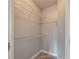 Small walk-in closet equipped with shelves for organization and wood grain vinyl flooring at 10 Ne Perimeter Summit Blvd # 3107, Atlanta, GA 30319