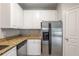 Kitchen with stainless refrigerator, granite countertops, and white cabinets at 10 Ne Perimeter Summit Blvd # 3107, Atlanta, GA 30319
