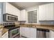 Bright kitchen features granite countertops, stainless steel appliances, and ample cabinet space at 10 Ne Perimeter Summit Blvd # 3107, Atlanta, GA 30319