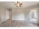 Spacious living room featuring wood grain vinyl flooring, two doors, and a ceiling fan at 10 Ne Perimeter Summit Blvd # 3107, Atlanta, GA 30319