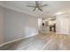 Spacious living room features a ceiling fan, with a view of the modern kitchen at 10 Ne Perimeter Summit Blvd # 3107, Atlanta, GA 30319