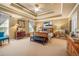 Spacious main bedroom featuring tray ceilings, carpet floors, and elegant furnishings at 4770 Shiloh Springs Rd, Cumming, GA 30040