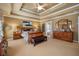 Large main bedroom showcases a tray ceiling, carpet, and sophisticated decor at 4770 Shiloh Springs Rd, Cumming, GA 30040