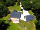 Aerial view of a house with a well-maintained landscape, a large deck, and a detached garage at 5300 Haynes Creek Dr, Loganville, GA 30052
