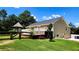 Beautiful home exterior with a wooden deck, gazebo, and well-manicured lawn at 5300 Haynes Creek Dr, Loganville, GA 30052