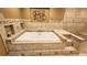Beautiful bathroom featuring a soaking tub with tile surround and shower combination at 5300 Haynes Creek Dr, Loganville, GA 30052