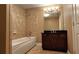 Charming bathroom with a soaking tub and vanity at 5300 Haynes Creek Dr, Loganville, GA 30052