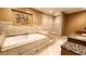 Luxurious bathroom featuring a soaking tub, tiled shower, and granite countertops for a spa-like experience at 5300 Haynes Creek Dr, Loganville, GA 30052