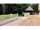 Spacious wooden deck with white railings and a charming gazebo overlooking the backyard at 5300 Haynes Creek Dr, Loganville, GA 30052