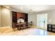 Bright dining room featuring a built-in hutch and shelving, a table, and access to an outdoor space at 5300 Haynes Creek Dr, Loganville, GA 30052