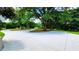 Long, paved driveway leading to the house, with mature trees and a green lawn at 5300 Haynes Creek Dr, Loganville, GA 30052