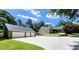 View of the home and detached three-car garage with a long driveway at 5300 Haynes Creek Dr, Loganville, GA 30052