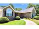 Attractive brick home featuring a well-maintained lawn and landscaping near the entrance at 5300 Haynes Creek Dr, Loganville, GA 30052