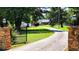 Inviting entrance with brick columns, iron gate and long driveway leading to the home at 5300 Haynes Creek Dr, Loganville, GA 30052