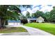 Charming stone home with a well-manicured lawn, long driveway, and detached garage at 5300 Haynes Creek Dr, Loganville, GA 30052