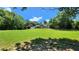 Spacious front yard with a lush lawn, mature trees, and a home with stone and siding at 5300 Haynes Creek Dr, Loganville, GA 30052