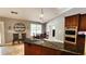 Spacious kitchen featuring stone countertops, stainless appliances, and a breakfast area with natural light at 5300 Haynes Creek Dr, Loganville, GA 30052