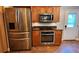 Updated kitchen featuring stainless steel appliances and wood cabinetry at 5300 Haynes Creek Dr, Loganville, GA 30052