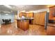 Spacious kitchen featuring granite countertops, tile flooring, central island, and wooden cabinetry at 5300 Haynes Creek Dr, Loganville, GA 30052
