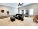 Spacious living room with neutral carpeting, a ceiling fan, and ample room for seating arrangements at 5300 Haynes Creek Dr, Loganville, GA 30052