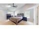 Relaxing main bedroom with carpet floors, vaulted ceiling, and natural light from the surrounding windows at 5300 Haynes Creek Dr, Loganville, GA 30052