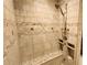 A tiled shower is the perfect spot to relax after a long day, featuring an adjustable shower head and two built-in shelves at 5300 Haynes Creek Dr, Loganville, GA 30052