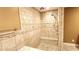 Luxurious tiled shower with a built-in bench and multiple shower heads, perfect for relaxation at 5300 Haynes Creek Dr, Loganville, GA 30052