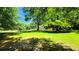 Large, well-maintained yard with mature trees and a wooden fence surrounding the property at 5300 Haynes Creek Dr, Loganville, GA 30052