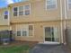 View of the backyard featuring sliding glass doors and a concrete patio with partial fencing at 1865 Ellison Lakes Nw Ct # 21, Kennesaw, GA 30152