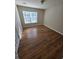 Cozy bedroom featuring new laminate flooring and a bright window at 1865 Ellison Lakes Nw Ct # 21, Kennesaw, GA 30152
