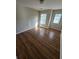 Bedroom with two windows providing natural light and dark brown wood flooring at 1865 Ellison Lakes Nw Ct # 21, Kennesaw, GA 30152