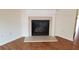 Cozy fireplace with decorative mantle and surround in a sunlit room at 1865 Ellison Lakes Nw Ct # 21, Kennesaw, GA 30152