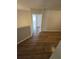 Well-lit hallway with wood flooring and access to multiple rooms at 1865 Ellison Lakes Nw Ct # 21, Kennesaw, GA 30152