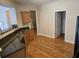 Kitchen with stainless sink, wood cabinets, and adjacent entrance to a well-lit room at 1865 Ellison Lakes Nw Ct # 21, Kennesaw, GA 30152
