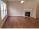 Spacious living room featuring a fireplace, lots of natural light and laminate flooring at 1865 Ellison Lakes Nw Ct # 21, Kennesaw, GA 30152