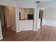 Open-concept living area showcasing laminate flooring and breakfast bar at 1865 Ellison Lakes Nw Ct # 21, Kennesaw, GA 30152