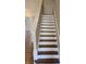 Classic staircase with white risers and stained treads leading to the upper level at 1865 Ellison Lakes Nw Ct # 21, Kennesaw, GA 30152